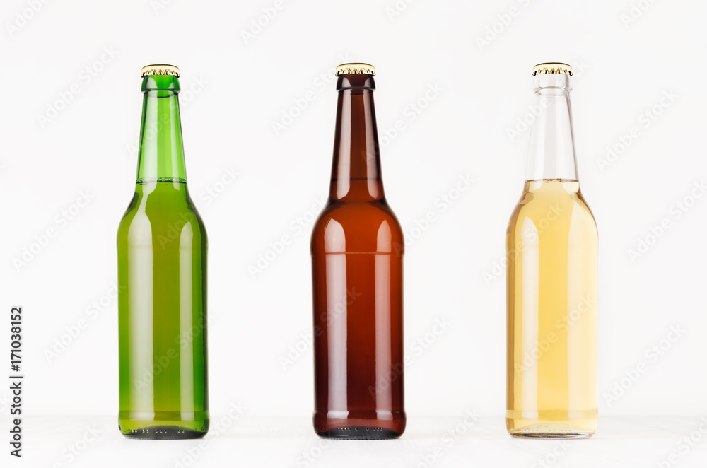 Collection longneck beer bottles 500ml different colors, mock up. Template for advertising, design, branding identity on white wood table.