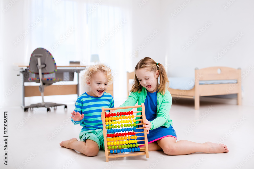 Kids playing with wooden abacus. Educational toy. Kids playing with wooden abacus. Educational toy.