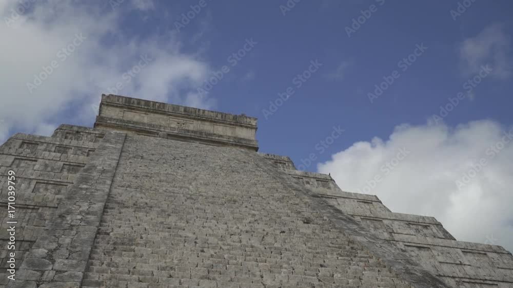 CHICHEN ITZA, MEXICO - MAY 25, 2017: Maya pyramid temple Kukulkan in peninsula Yucatan at sunny summer day CHICHEN ITZA, MEXICO - MAY 25, 2017: Maya pyramid temple Kukulkan in peninsula Yucatan at sunny summer day