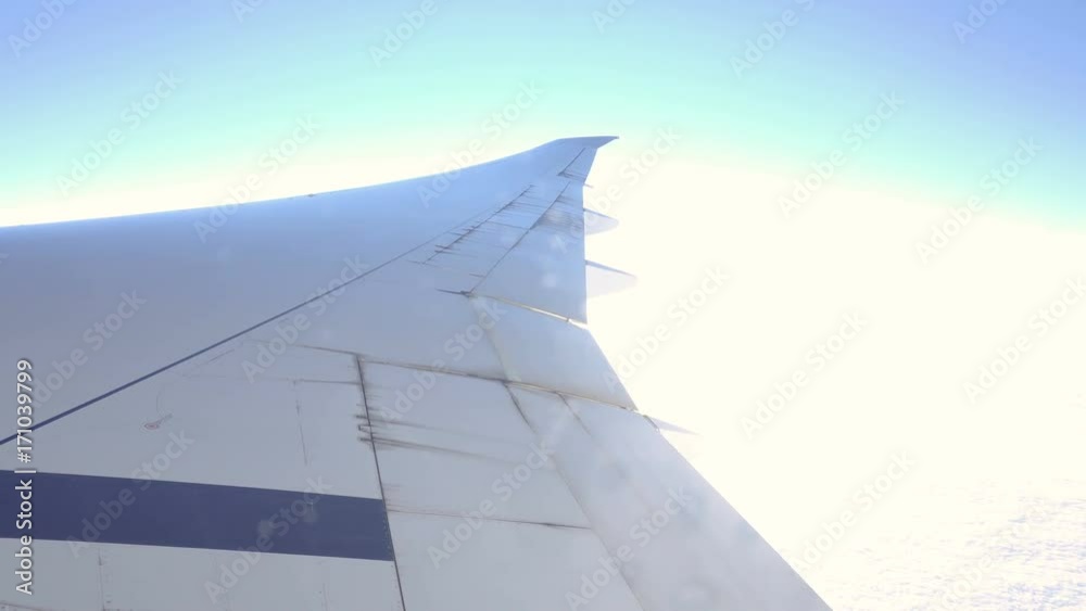 View from airplane window to the sky and plane wing, nobody View from airplane window to the sky and plane wing, nobody