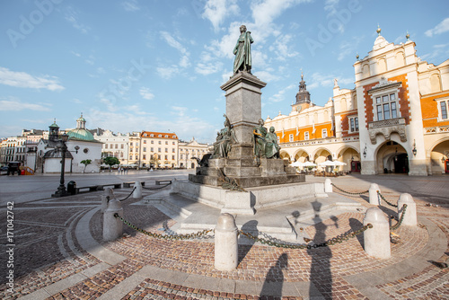 Cityscape view on the Market square with Cloth Hall building and Adam Mickiewicz monument during the morning light in Krakow, Poland