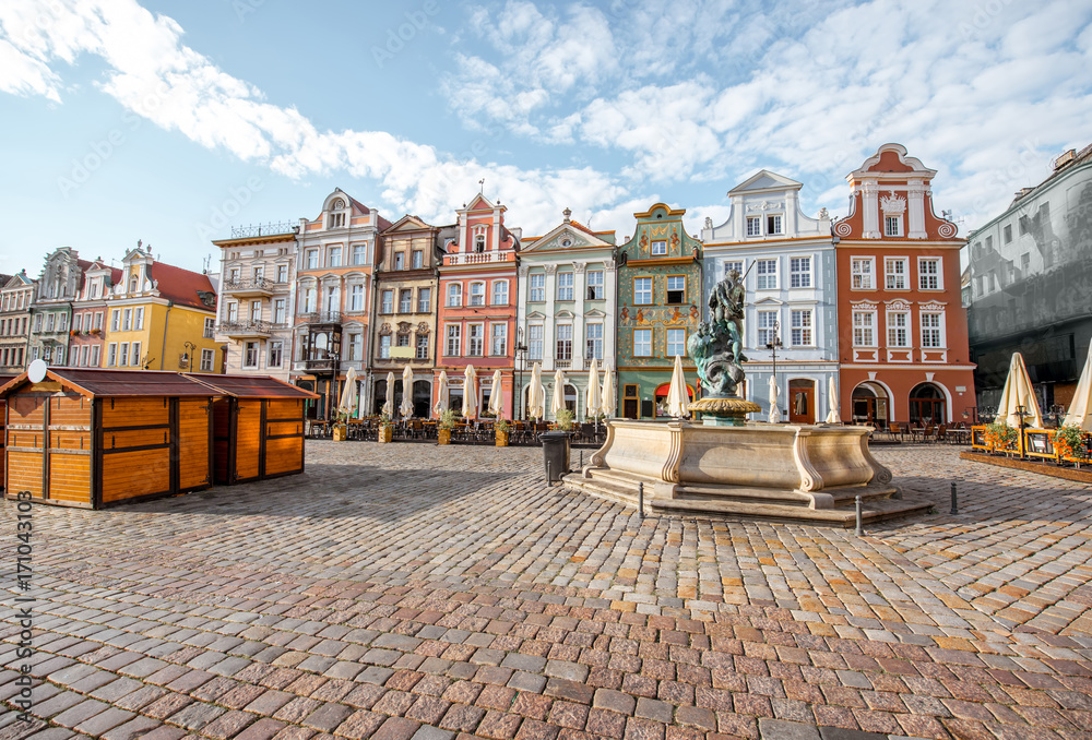 View on the beautiful old buildings with Neptune fountain on the Maket square in Poznan city during the morning light in Poland