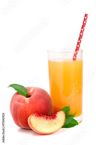 Glass of fruit juice with straw and cut peaches isolated on white background