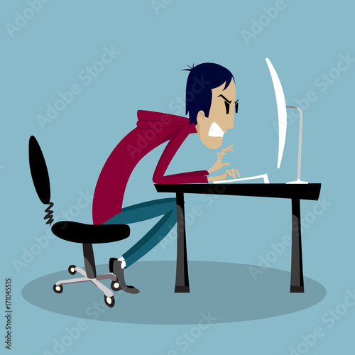 Angry man typing on keyboard and looking at monitor