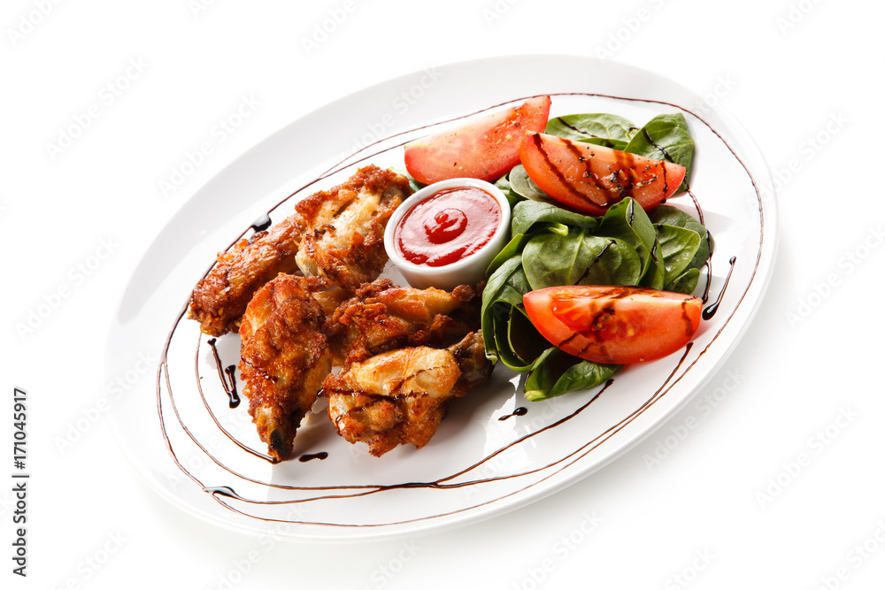 Grilled chicken drumsticks on white background 