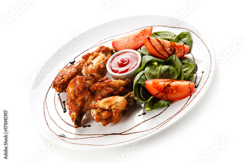 Grilled chicken drumsticks on white background 