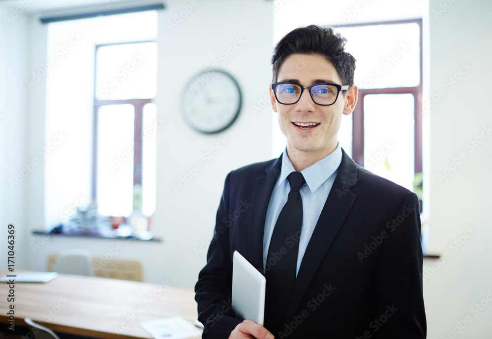 Elegant financial expert with tablet looking at camera in office Elegant financial expert with tablet looking at camera in office