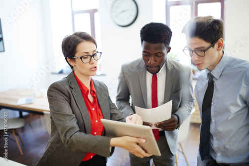 Confident woman explaining her subordinates online information or project