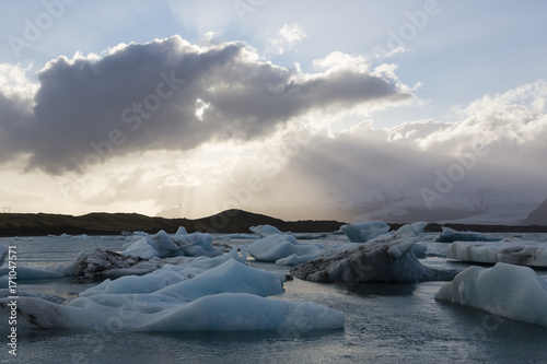 Icebergs are floating in the Glacier lagoon in Jokulsarlon during a sunset near the Black Beach (Diamond Beach) near Hofn in the south east of Iceland