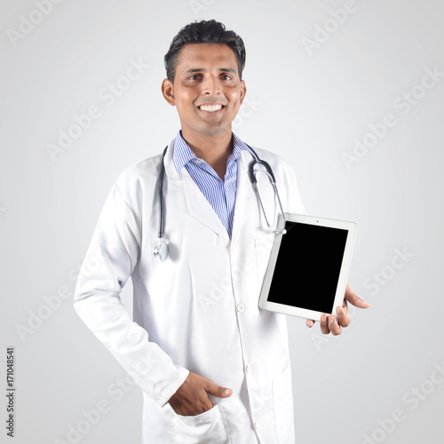 Doctor holding tablet pc very professionally isolated