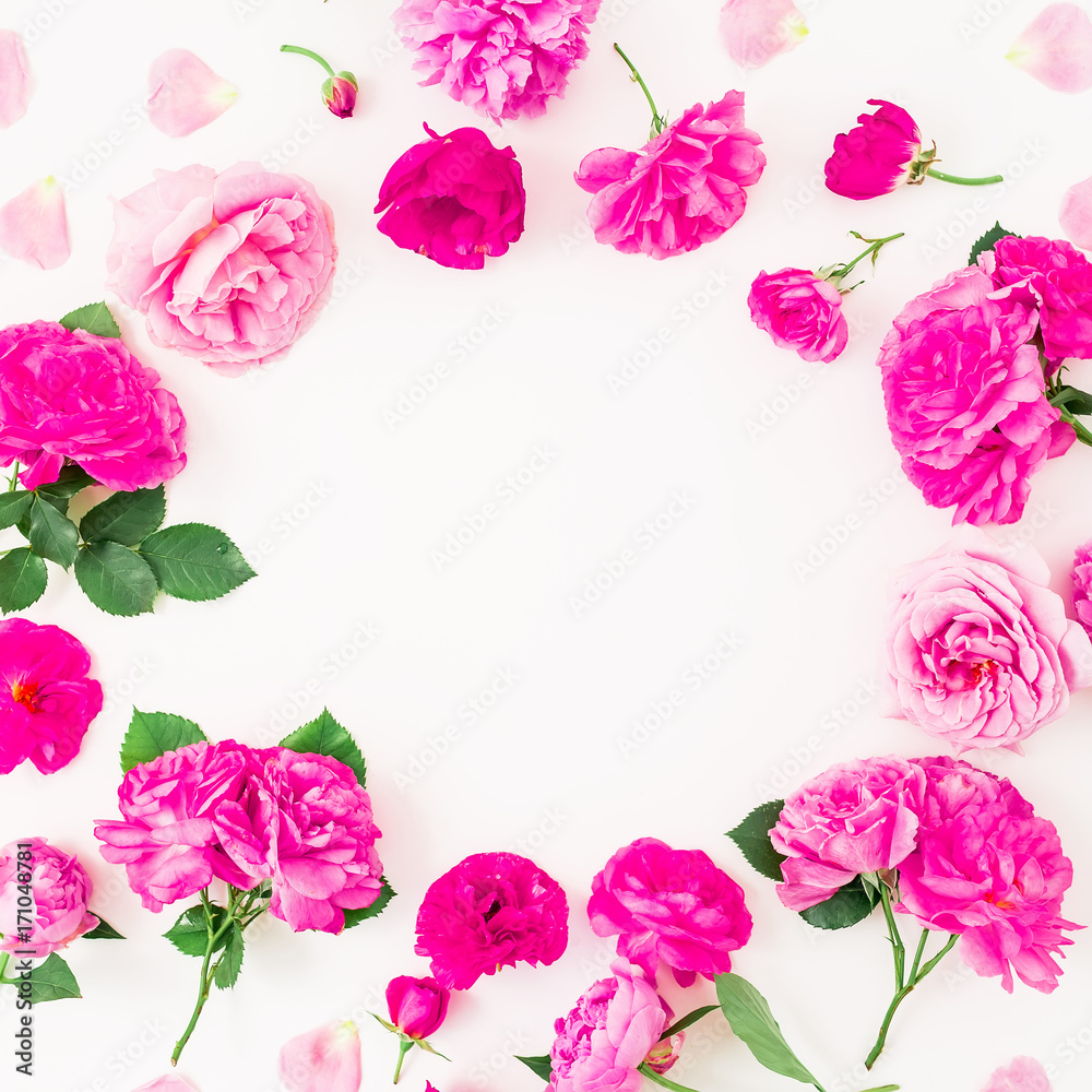 Floral round frame with pink roses and leaves on white background. Flat lay, top view.
