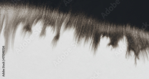 Fotografía closeup black ink border spreading on wet paper top view