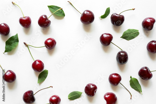 Creative fresh cherry pattern background with copy space. Isolated fruit.