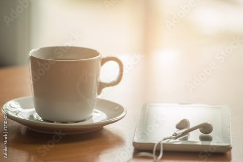 Business concept. Office supply on desk table with cup of coffee and analysis chart  smartphone  keyboard  notebook  pen earphones on desk.