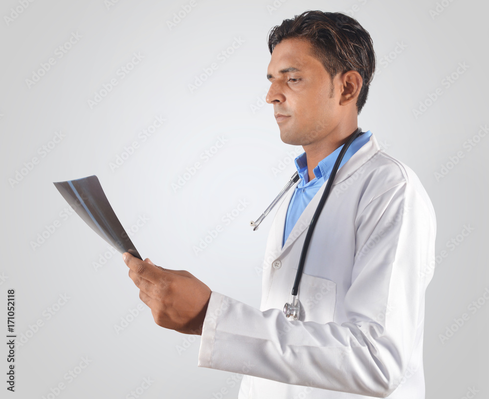 Doctor with stethoscope examining x-ray Doctor with stethoscope examining x-ray