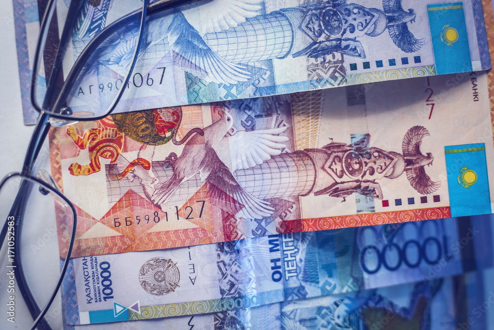 Kazakhstan money and glasses. Paper banknotes of tenge.