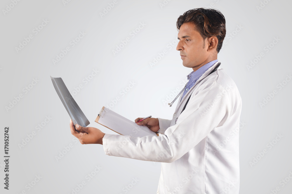 Doctor with stethoscope examining x-ray Doctor with stethoscope examining x-ray