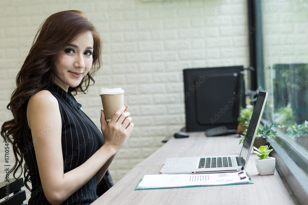 Business woman have a break with coffee in hand while working at office. Business woman have a break with coffee in hand while working at office.