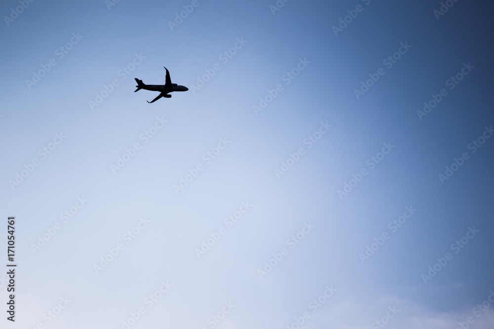 Airplane flying in the blue sky silhouetted. Airplane flying in the blue sky silhouetted.