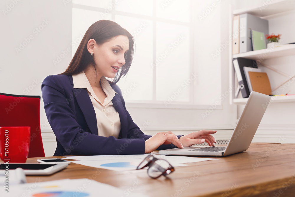 Business woman working on laptop at office Business woman working on laptop at office