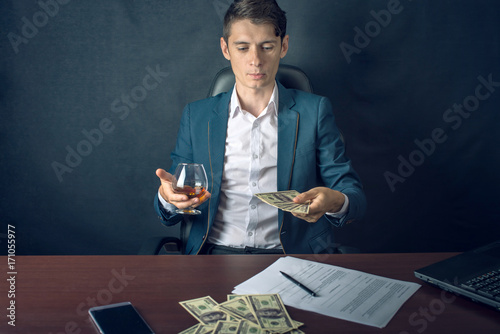 Businessman in suit throwing money in the form of hundred dollar bills. Concept of Investments and successful business
