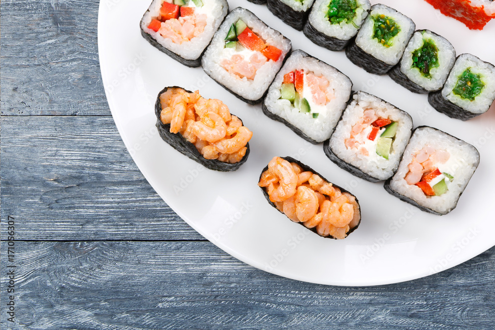 Colorful set of sushi and rolls top view on wood, closeup
