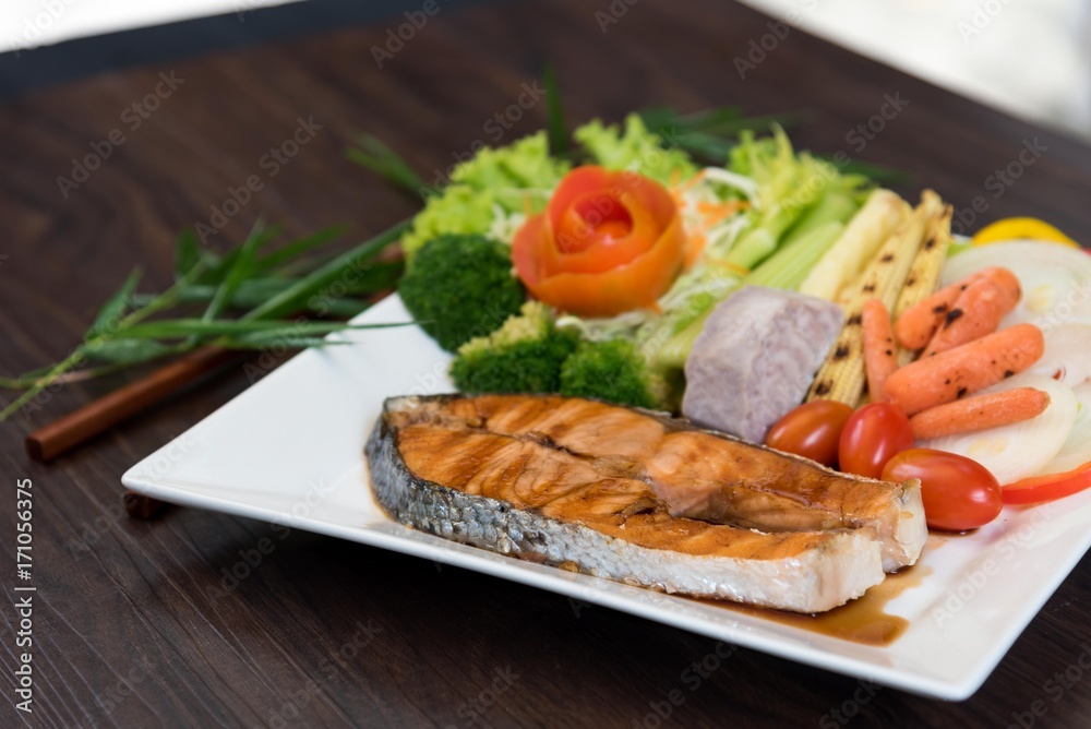 Salmon fillets. Grilled salmon, salmon steak on old wooden table, vintage style 