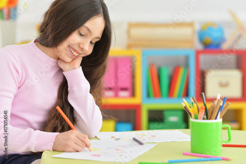 Teenage girl drawing with pencil
