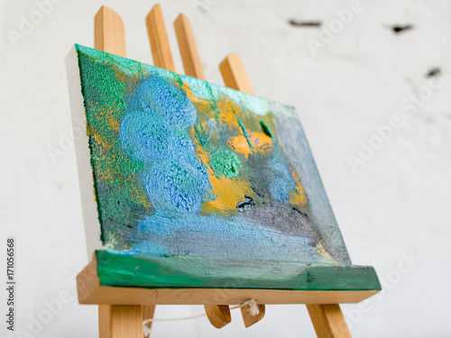 Colorful abstract painting in selective focus. Artistic picture on easel closeup, bright colors, art concept