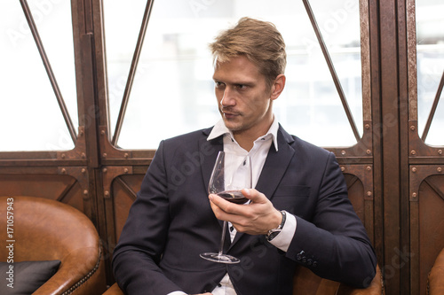 Portrait of a handsome Businessman sitting in restaurant, Man with Business Concept. photo