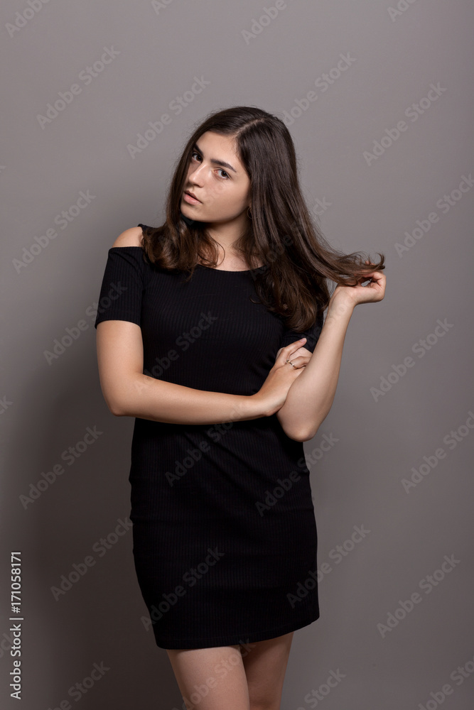 Portrait of a beautiful girl on a gray background Portrait of a beautiful girl on a gray background