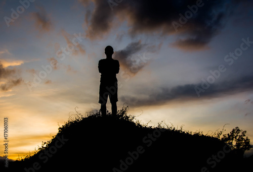 silhouette man on hill with sky for background