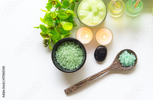 Thai Spa Treatments aroma therapy  salt and nature green sugar scrub and rock massage with green orchid flower on wooden white with candle. Thailand.  Healthy Concept. copy space,select and soft focus