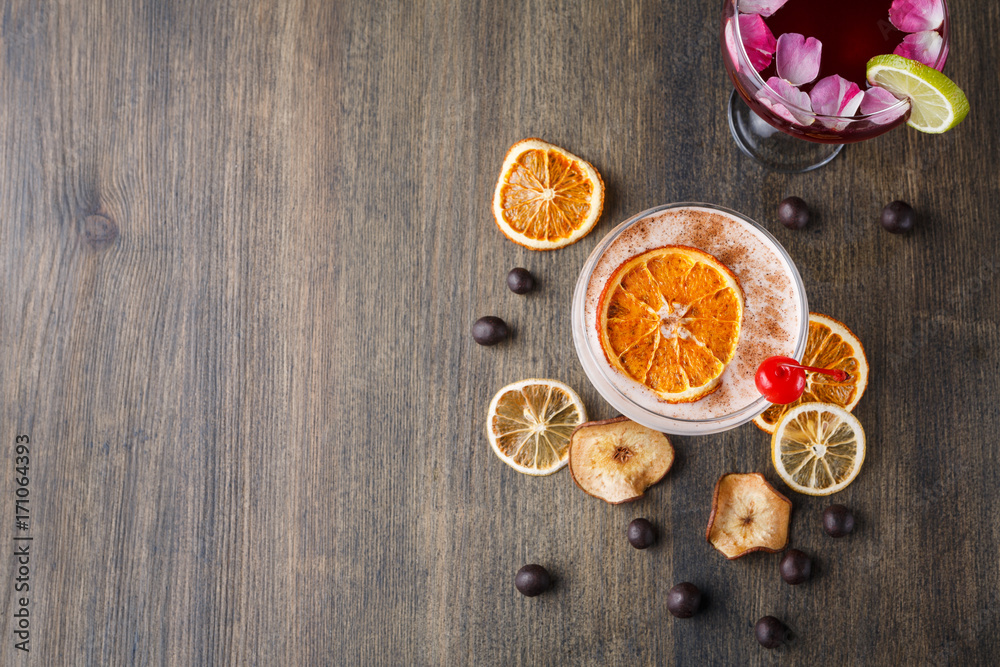 Colorful cocktails over rustic wood background