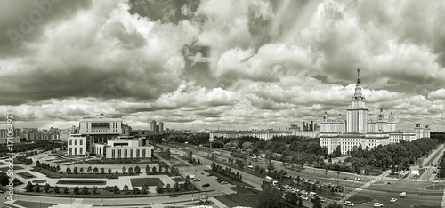 Black and white wide angle panoramic landscape view of dramatic clouds over the sunny summer campus of Lomonosov Moscow State University