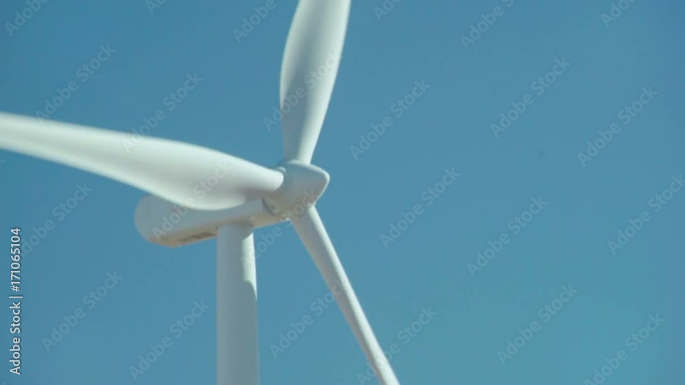 Spinning Wind Turbine. Close on a horizontal axis wind turbine (HAWT) tower spinning in the wind. Spinning Wind Turbine. Close on a horizontal axis wind turbine (HAWT) tower spinning in the wind.