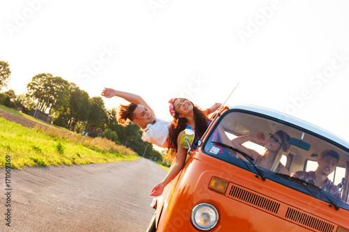 Fototapeta Naklejka Na Ścianę i Meble -  Hippie friends in a van on a road trip