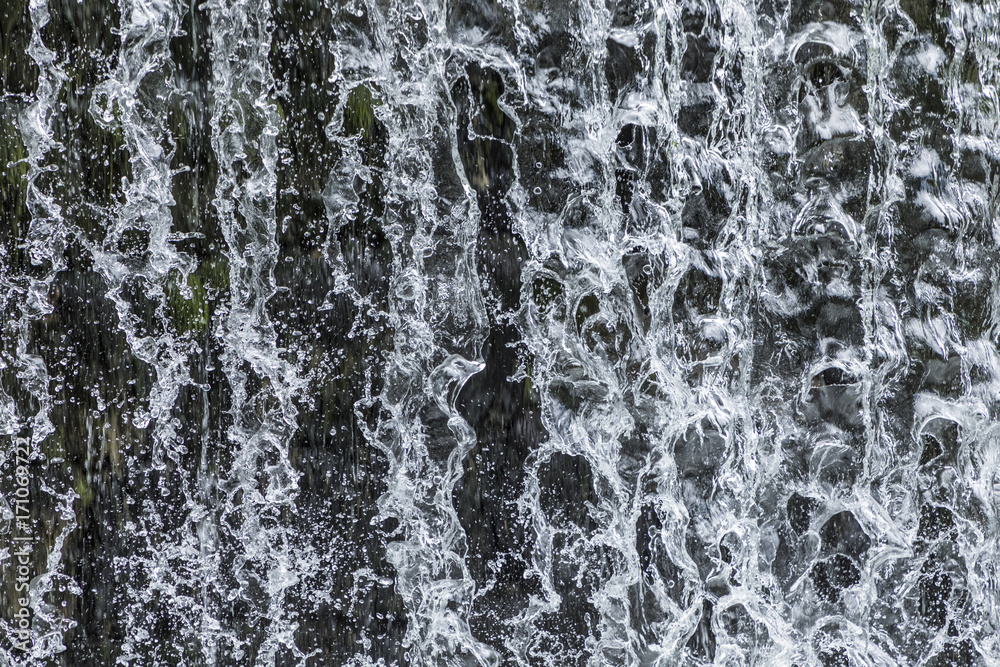 Fototapeta premium pattern of flowing water at a waterfall gives a harmonic background