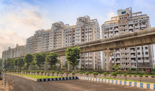 Tall city residential buildings with under construction over bridge at Kolkata, India.