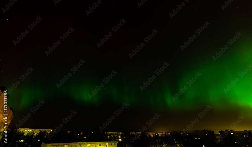 Intense northern lights (Aurora borealis) over city of Riga