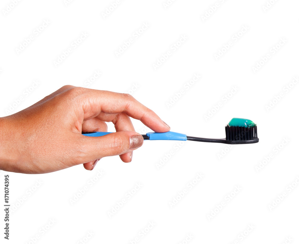 Female hand holding a Toothbrush with toothpaste isolated on white background Female hand holding a Toothbrush with toothpaste isolated on white background