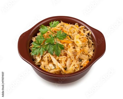 Stewed cabbage meal in clay bowl, isolated on white