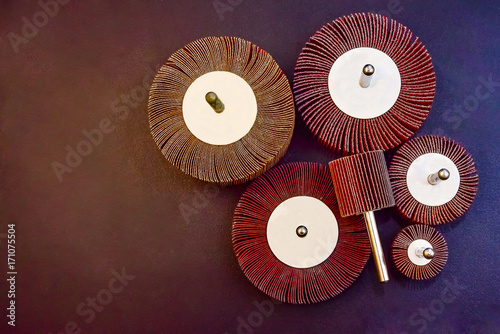 Flap Wheel. A pile of color abrasive Flap Wheel industrial on wood background texture. sandpaper wheel tool - professional equipment photo