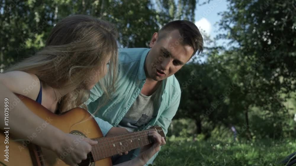 The musician teaches the guitar student The musician teaches the guitar student