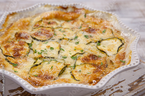 Low carb Green Zucchini casserole with cheese in baking dish