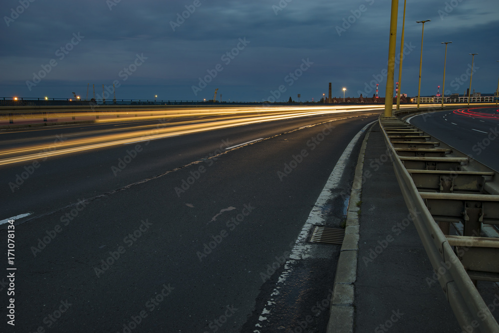 Fototapeta premium The road leading to Szczecin after sunset, traces of lights of cars