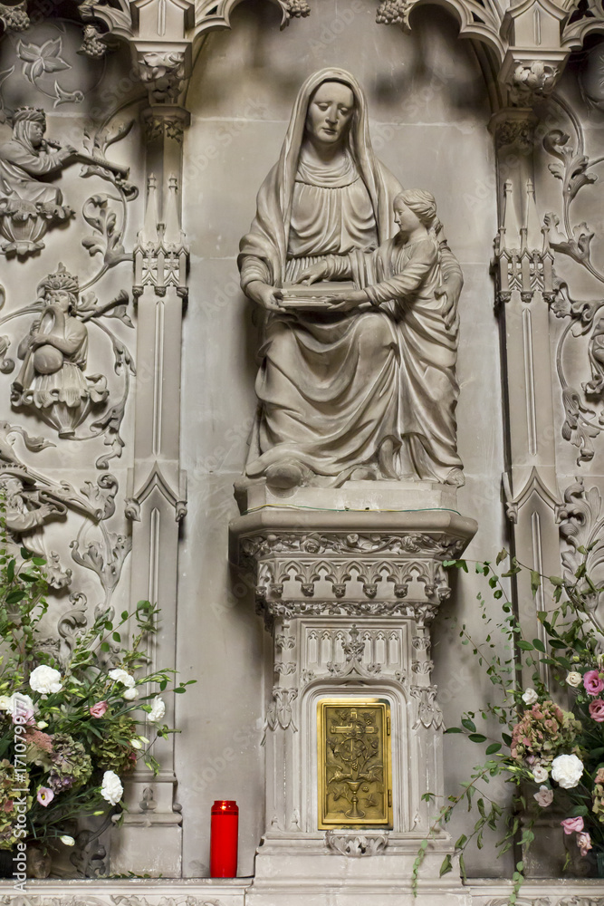 .Poitiers, France - September 12, 2016: Very old church Notre Dame la Grande in Poitiers,  in the interior of one of the side altars with a statue of the Virgin Mary with Jesus