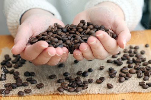 Coffee lover holds roasted beans