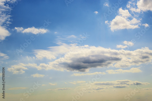 Blue sky with white Cumulus clouds. Day, background.