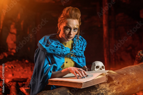 Beautiful red haired witch with the spellbook.